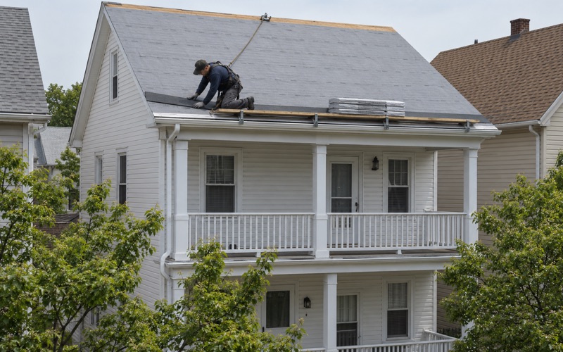 The starter course going down along a new drip edge as a full roof replacement begins on a Bayonne two-family.